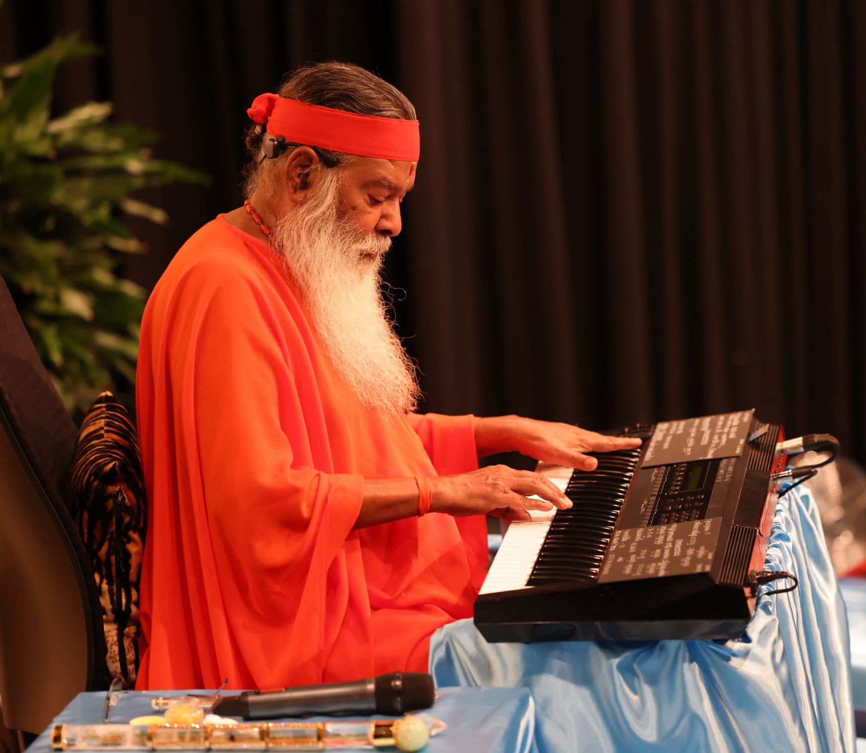 Sri Swamiji at keyboard — Healing Music Experience performance